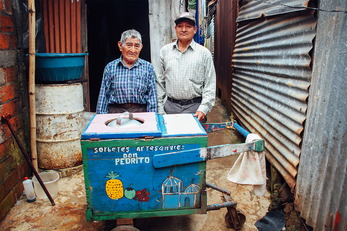 Pedro, left, was a sponsored elder. He passed away in 2020. For more than 50 years, he made and sold artisanal sorbet from a cart on the streets of Ataco, El Salvador. 